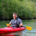 Traveler Liam O'Connell kayaking in a serene river
